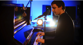 Josef Pitura-RIley plays piano in his studio.